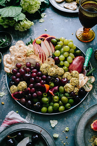 Overhead view of gourmet charcuterie board with fruits and cheese