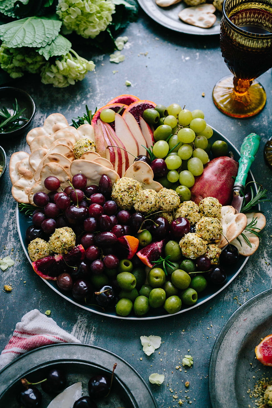 Overhead view of gourmet charcuterie board with fruits and cheese