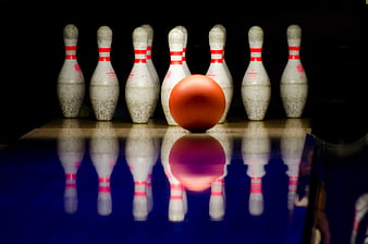 Orange Bowling Ball and Pins on Lane with Reflection