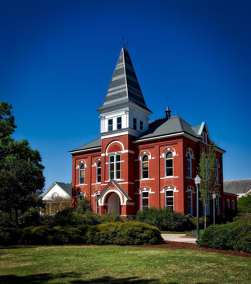 Red Brick Historic Building with Steeple Against Blue Sky
