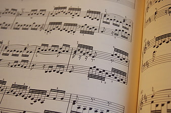 Close-up of open piano sheet music with classical notes