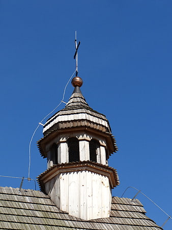Wooden Church Tower Top With Cross Against Blue Sky