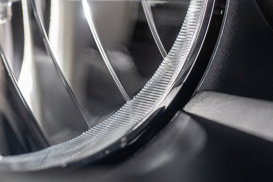 Close-up of car headlight lens texture and reflection