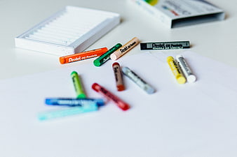 Colorful Pentel Oil Pastels Scattered on White Paper