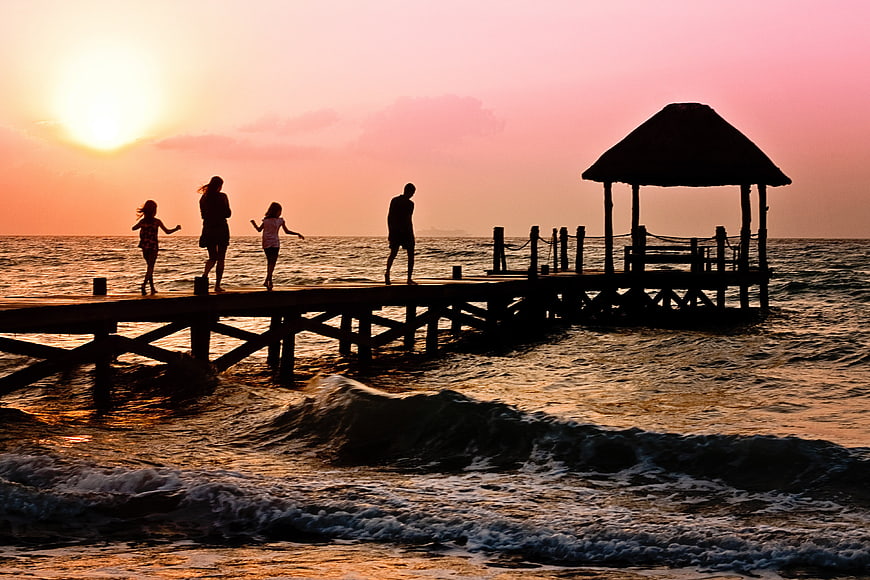 Family Silhouette on Wooden Pier at Sunset