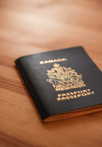 Canadian Passport on Wooden Table for Travel
