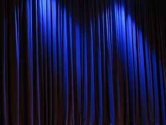 Blue Stage Curtain with Dramatic Lighting