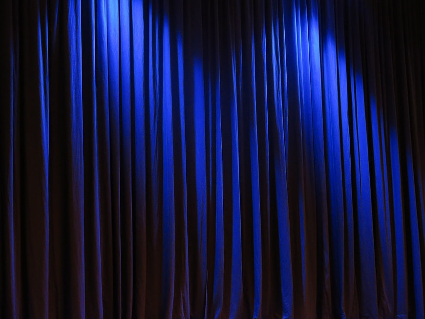 Blue Stage Curtain with Dramatic Lighting