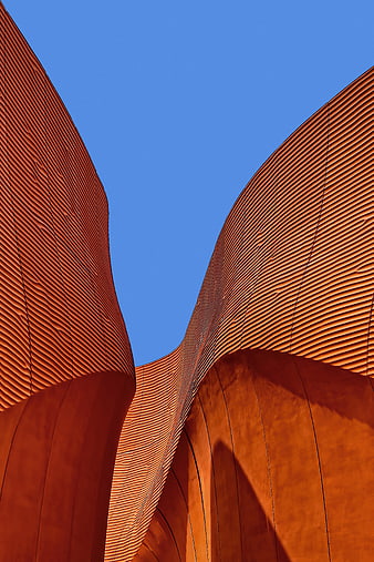 Abstract Curved Orange Architecture Against Blue Sky