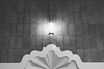 Black and white architectural detail with hanging lamp and tiles