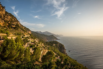 Scenic coastal mountain landscape with winding road and sea view
