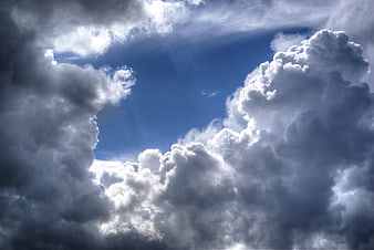 Dramatic blue sky with fluffy white cumulus clouds