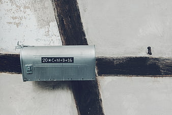 Vintage metal mailbox on rustic timber frame wall