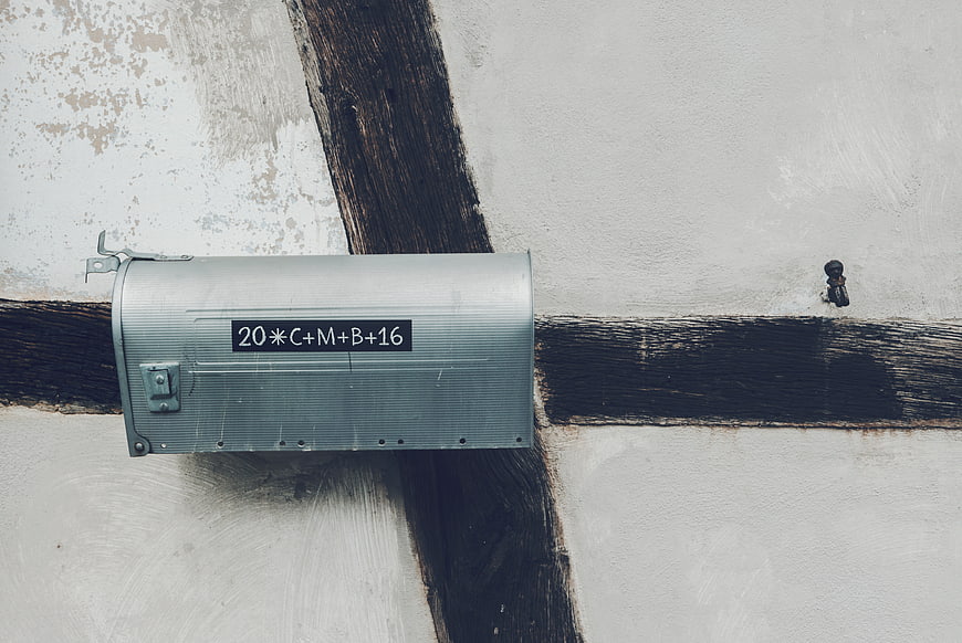 Vintage metal mailbox on rustic timber frame wall
