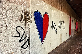 Blue and Red Heart Graffiti on Urban Concrete Wall