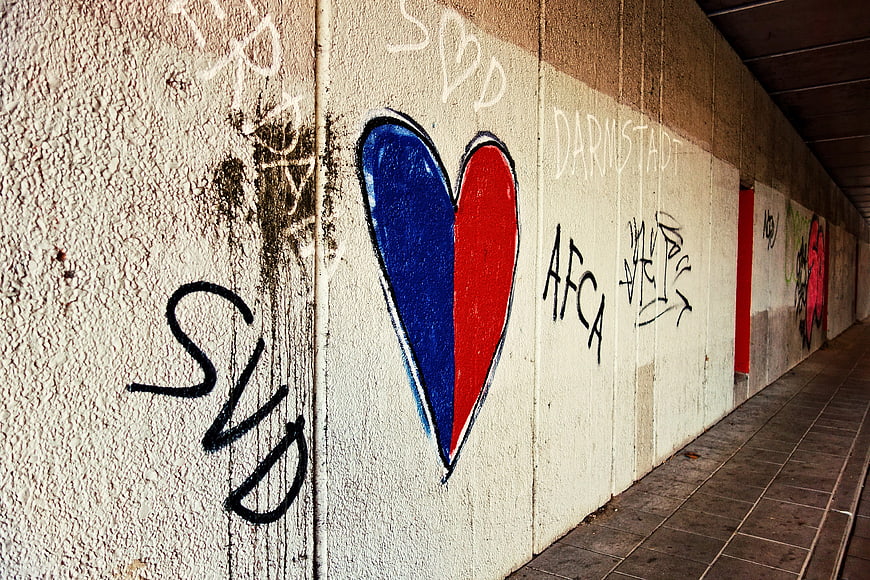Blue and Red Heart Graffiti on Urban Concrete Wall