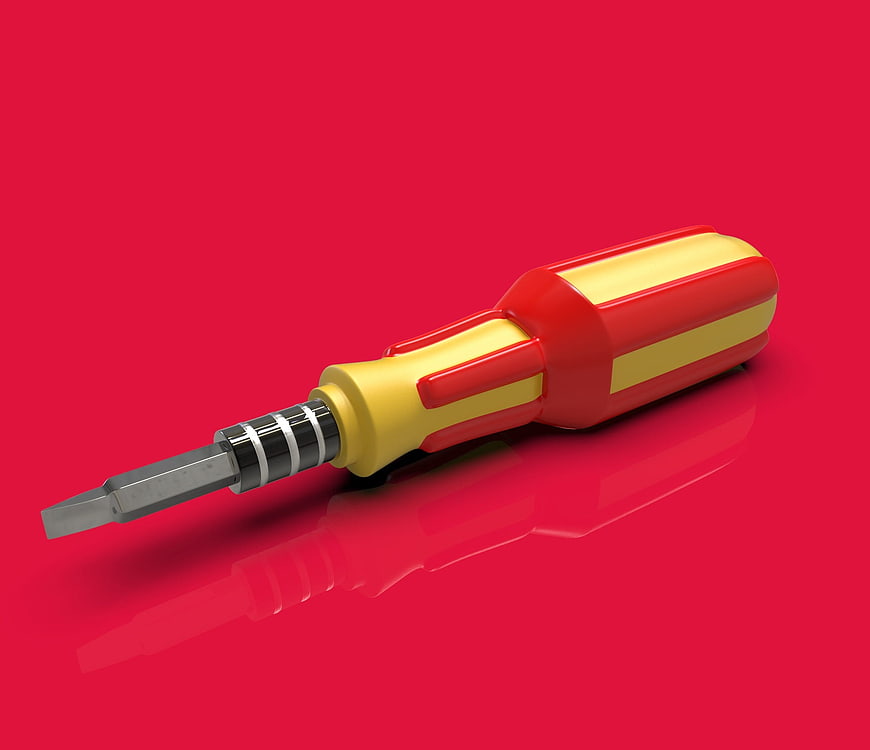Red and Yellow Flathead Screwdriver on Red Background