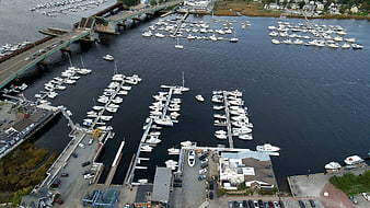 Aerial View of Busy Harbor with Bridge and Marina