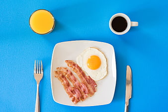 Top View of Classic Breakfast with Bacon, Eggs, Coffee, and Juice
