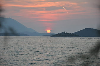 Serene Sunset Over Adriatic Sea with Distant Mountains