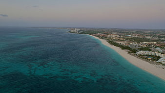 Aerial View of Turquoise Coastline and Resort Town at Dusk