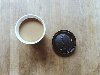 Top View of Coffee Cup and Lid on Wooden Table
