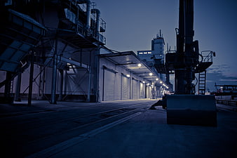 Industrial Port Facility At Dusk With Heavy Machinery
