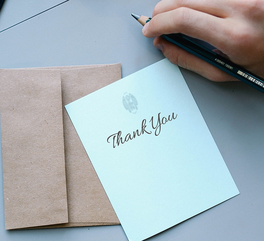 Hand Writing Thank You Note on Card with Pencil