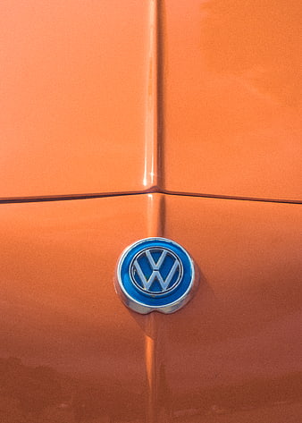Close-up of Volkswagen Logo on Orange Car Body