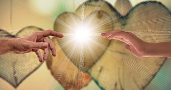 Two hands reaching for divine light with heart background