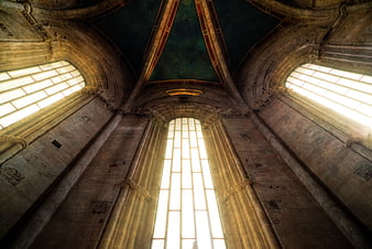 Gothic Cathedral Interior with Arched Windows and Sunbeams