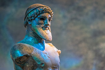 Close-up of ancient Greek bronze statue of Poseidon with blue patina
