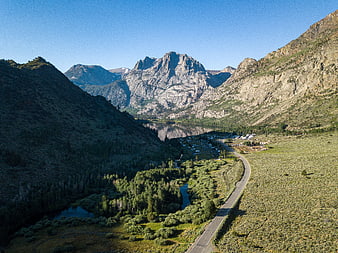 Aerial View of Winding Mountain Road and Alpine Lake