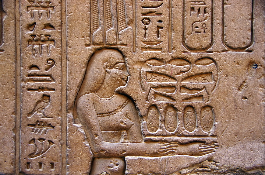 Ancient Egyptian Sandstone Relief with Hieroglyphics and Figure