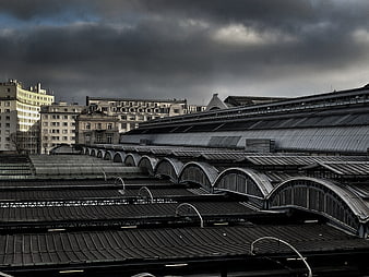 Dramatic Parisian Train Station Roofs Under Stormy Sky
