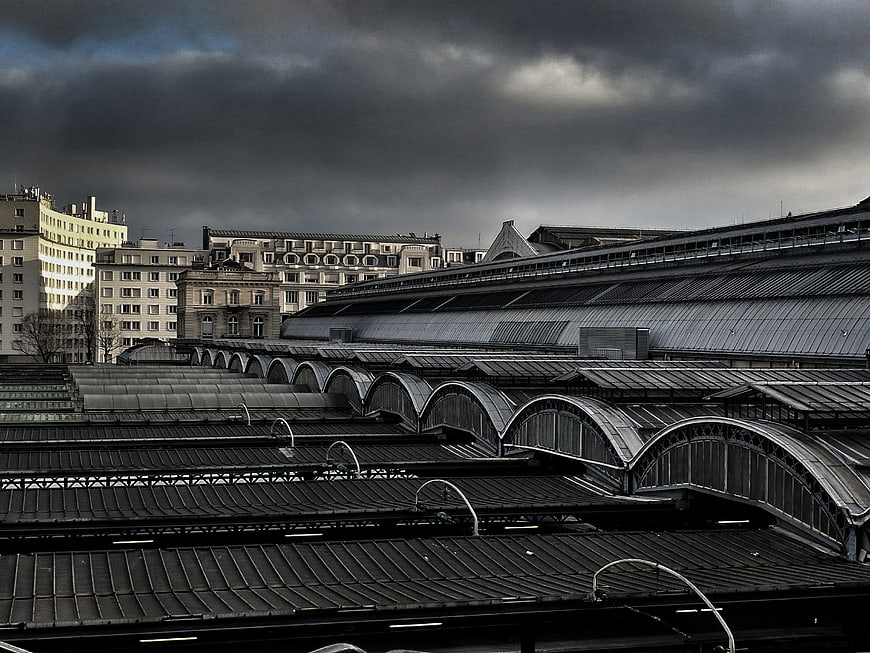 Dramatic Parisian Train Station Roofs Under Stormy Sky