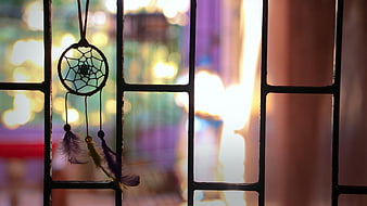 Dreamcatcher Hanging on Window Grid with Bokeh Background