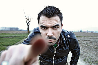 Man Pointing Finger Directly At Camera In Outdoor Field