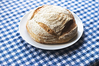 Rustic Sourdough Bread Loaf on Blue Checkered Tablecloth