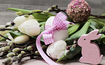 Easter egg with pink ribbon, white tulips, and wooden bunny