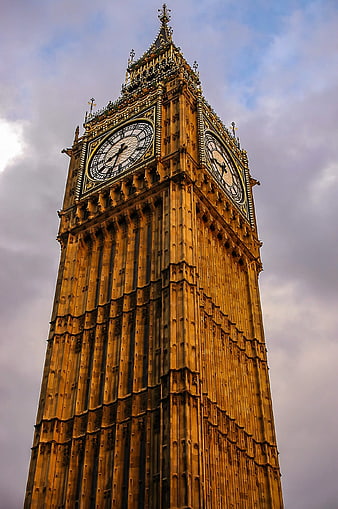Low angle view of Big Ben clock tower against cloudy sky
