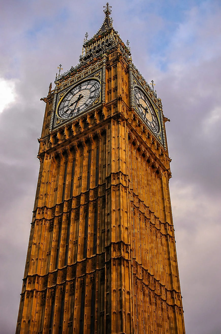 Low angle view of Big Ben clock tower against cloudy sky