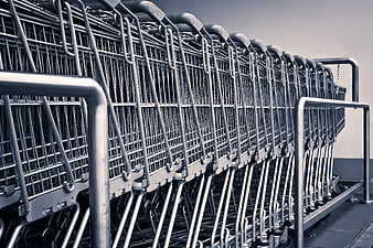 Row of nested metal shopping carts in a parking lot