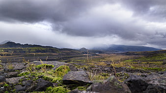 Dramatic Icelandic Landscape with Mossy Rocks and Cloudy Sky