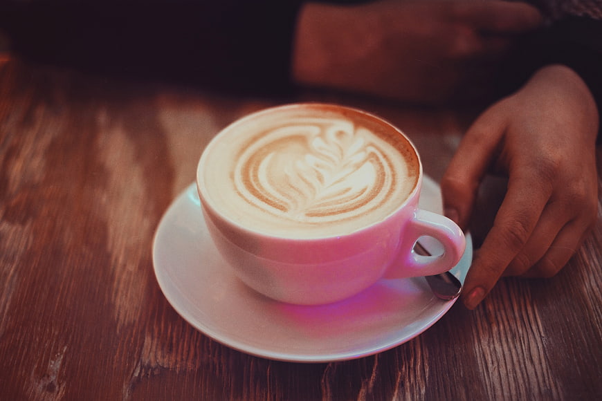 Pink Coffee Cup with Latte Art on Wooden Table