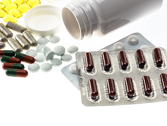 Assorted Medication Pills and Supplements on White Background