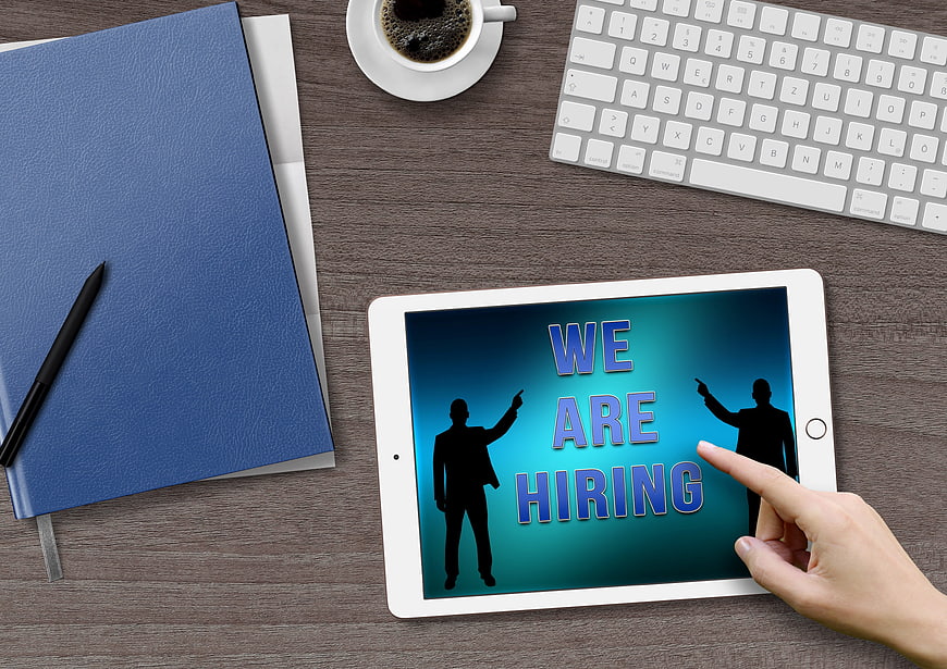 We Are Hiring Concept On Tablet In Modern Office Workspace