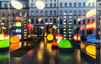 Colorful illuminated spheres in modern urban shop window display