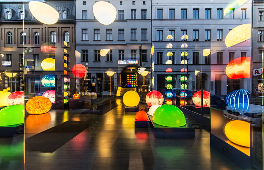 Colorful illuminated spheres in modern urban shop window display