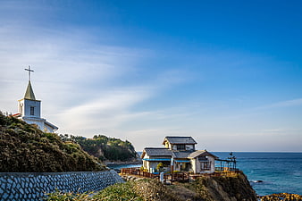 Coastal Church and Traditional Houses on a Cliffside